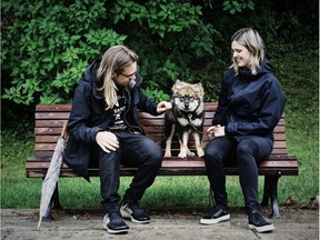 On a  rainy morning Orion the Finnish Lapphund sits in Prince Albert Park with owners Katherine Rousseau and Pete Williams.