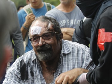 Éric Roy was attended to by medics after being attacked for carrying a Quebec Patriote flag at a counter-demonstration against far-right group La Meute Sunday, August 20 in Quebec City.