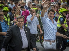 Canadian Prime Minister Justin Trudeau (right) joins Montreal Mayor Denis Coderre as they walk in the Pride parade along René-Lévesque Boulevard in Montreal on Sunday.
