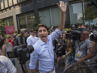 Canadian Prime Minister Justin Trudeau walks along Boulevard René-Lévesque during the Pride parade in Montreal  on Sunday, August 20, 2017.