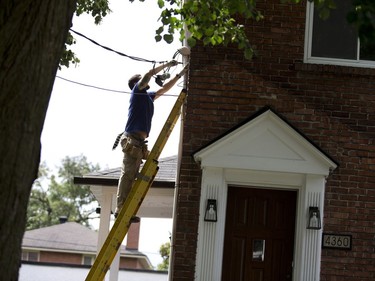 Residents hire local electricians so Hydro Quebec can connect power back to their houses on West Hill Avenue in NDG, Montreal, August 23, 2017.   (Christinne Muschi / MONTREAL GAZETTE)