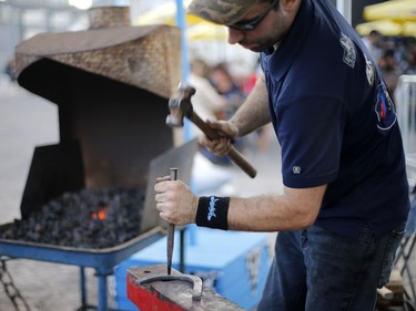 Francis Dufresne Cyr demonstrates the art of making horseshoes at the rodeo in the Old Port of Montreal, Aug. 24, 2017.