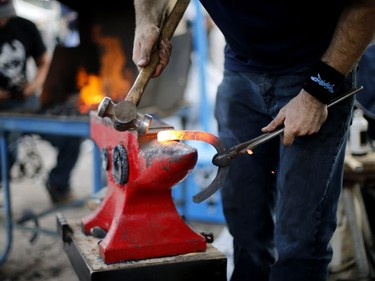 Francis Dufresne Cyr demonstrates the art of making horseshoes at the rodeo in the Old Port of Montreal, Aug. 24, 2017.