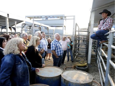 A tour is given to the public to see and answer questions on where and how the bucking bulls are penned at the rodeo in the Old Port of Montreal, Aug. 24, 2017.