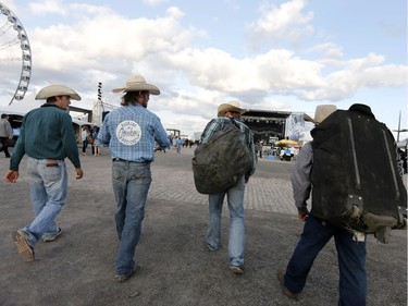 Contestant arrive with their gear for the rodeo in the Old Port of Montreal, Aug. 24, 2017.