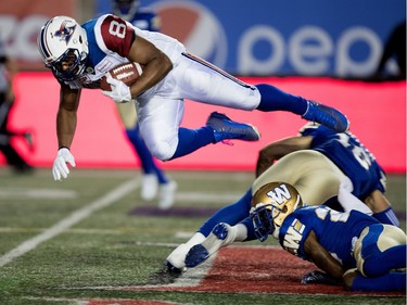 Montreal Alouettes slotback Nik Lewis has his legs taken out from under him by Winnipeg Blue Bombers defensive back Taylor Loffler during CFL action at Molson Stadium in Montreal on Thursday August 24, 2017.