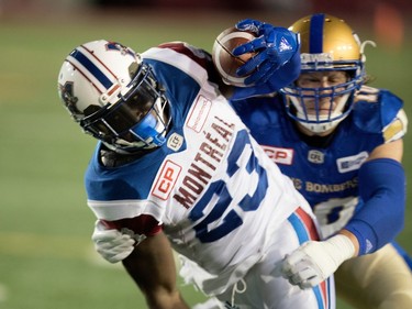 Montreal Alouettes running back Brandon Rutley is dragged to the turf by Winnipeg Blue Bombers linebacker Sam Hurl during CFL action at Molson Stadium in Montreal on Thursday August 24, 2017.