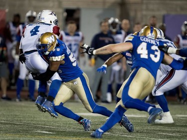 Montreal Alouettes quarterback Darian Durant is tackled by Winnipeg Blue Bombers defensive lineman Jamaal Westerman at Molson Stadium on Thursday.