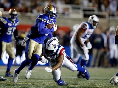 Winnipeg Blue Bombers defensive back Chris Randle is tackled by Montreal Alouettes slotback Nik Lewis during CFL action at Molson Stadium in Montreal on Thursday August 24, 2017. Randle intercepted the ball allowing the Blue Bombers to win the game on a field goal in overtime.