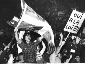 Philippe Beauchamp of Longueuil waves Quebec flag during emotional rally in defence of Bill 101 at Paul Sauve Arena in 1988.