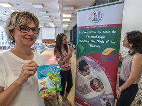 EMSB dietitian Sylvie Beaudry displays a nutrition passport that will be distributed to kindergarten students. Behind her are dietitians Giuliana Di Quinzio and Pamela Yiptong (right).