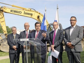Montreal Mayor Denis Coderre, flanked by (from left) city councillor Yves Gignac, Finance Minister Carlos Leitao, Municipal Affairs Minister Martin Coiteux and Pierrefonds-Roxboro borough Mayor Jim Beisi, provides an update on construction of the expanded Pierrefonds Library last Friday.