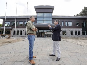 St-Lazare Mayor Robert Grimaudo, right, talks with the town's director general Serge Tremblay outside the new town hall on Aug. 25.