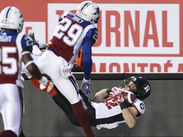 Ottawa Redblacks Greg Ellingson catches the ball out of bounds while being covered by Montreal Alouettes Jonathon Mincy and Dondre Wright during first half of Canadian Football League game in Montreal Thursday August 31, 2017.