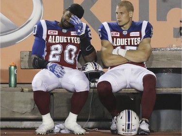 Montreal Alouettes Tyrell Sutton, left and Samuel Giguère sit on the bench in the closing minutes of a loss to the Ottawa Redblacks during a Canadian Football League game in Montreal, Thursday August 31, 2017.