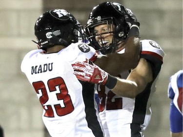 Ottawa Redblacks Greg Ellingson, right, celebrates his fourth-quarter touchdown with teammate Mossis Madu during Canadian Football League game against the Montreal Alouettes in Montreal, Thursday August 31, 2017.