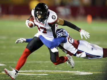 Ottawa Redblacks Josh Stangby is tackled by Montreal Alouettes Tyree Hollins during first half of Canadian Football League game in Montreal, Thursday August 31, 2017.