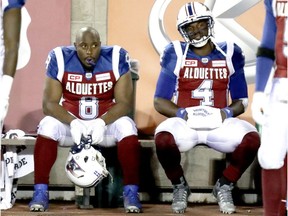 Alouettes Nik Lewis, left, and Darian Durant sit on the bench in the closing minutes of loss to the Ottawa Redblacks Thursday night at Molson Stadium.