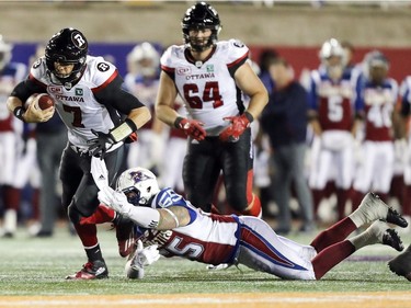 Montreal Alouettes Gabriel Knapton trips up Ottawa Redblacks quarterback Trevor Harris during first half of Canadian Football League game in Montreal, Thursday August 31, 2017.