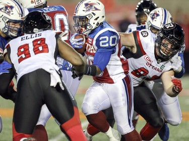 Montreal Alouettes running back Tyrell Sutton is pursued by the Ottawa Redblacks Avery Ellis in first half of Canadian Football League game in Montreal, Thursday August 31, 2017.