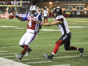 Montreal Alouettes Darian Durant is pushed out of bounds by Ottawa Redblacks Antoine Pruneau during first half of Canadian Football League game in Montreal, Thursday August 31, 2017.