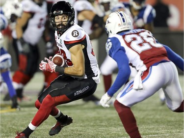 Ottawa Redblacks receiver Brad Sinopoli turns upfield after catching a pass in front of Montreal Alouettes Tyree Hollins during first half of Canadian Football League game in Montreal, Thursday August 31, 2017.