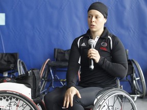 Cindy Ouellet explains how to use a wheelchair during a wheelchair basketball demonstration with other local athletes and journalists at Centre Claude-Robillard on April 26, 2016.