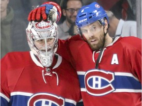 Montreal Canadiens goalie Carey Price gets a pat on the head from defenceman Shea Weber following the team's 5-1 victory over the Anaheim Ducks on Dec. 20, 2016, in Montreal. Beginning in 2018-19, Price and Weber will have a combined salary cap hit of US$18.3 million.