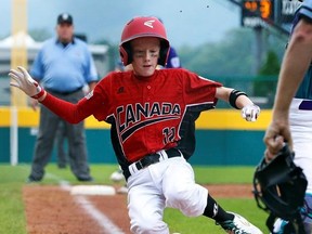 Canadian Daniel Orfaly begins his slide to score on a single by Grayson Frers in the third inning of an international pool play baseball game against Italy at the Little League World Series tournament in South Williamsport, Pa., Thursday, Aug. 17, 2017.