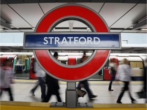 Rail passengers pass through Stratford Station adjacent to the Olympic Park on July 31, 2012 in London, England.