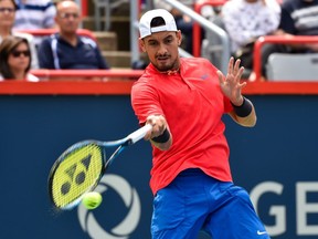 Australia's Nick Kyrgios hits a return against Viktor Troicki of Serbia in Rogers Cup action at Uniprix Stadium.