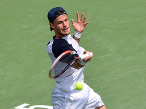 Diego Schwartzman of Argentina hits a return against Jared Donaldson of the U.S. Thursday at Uniprix Stadium in Montreal.