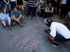 Mourners mark the spot where Heather Heyer was killed when a car plowed into a crowd of people protesting against the white supremacist Unite the Right rally on Aug. 13, 2017 in Charlottesville, Virginia.