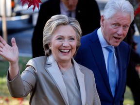 Hillary Clinton and Bill Clinton greet supporters after casting their ballots in Chappaqua, New York on November 8, 2016.