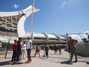 Refugees and some of their supporters mingle outside Olympic Stadium in Montreal on August 5, 2017.