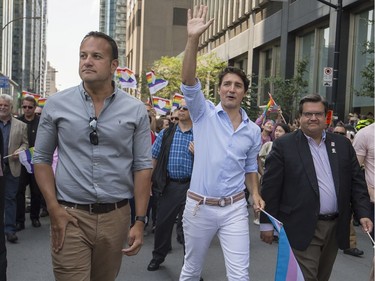 Leo Varadkar, Taoiseach of Ireland left, Canadian Prime Minister Justin Trudeau middle, and  Montreal Mayor Denis Coderre right, walk along Boulevard René-Lévesque during the Pride parade in Montreal on Sunday August 20, 2017.