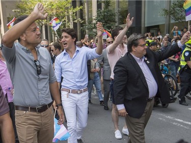Leo Varadkar, Taoiseach of Ireland left, Canadian Prime Minister Justin Trudeau middle, and  Montreal Mayor Denis Coderre right, walk along Boulevard René-Lévesque during the Pride parade in Montreal, Sunday, August 20, 2017.