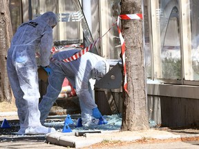 Forensic police inspect the site of a car crash on Aug. 21, 2017, in Marseille. At least one person died after a car crashed into two bus stops in the southern French port city.