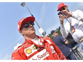 Ferrari's Finnish driver Kimi Raikkonen walks in the paddocks prior to the the qualifying session at the Spa-Francorchamps circuit in Spa on August 26, 2017 ahead of the Belgian Formula One Grand Prix. / AFP PHOTO / LOIC VENANCE