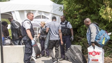 A group of asylum seekers cross the Canadian border at Champlain, N.Y., Friday, August 4, 2017.
