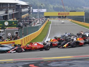 Mercedes driver Lewis Hamilton of Britain, left, leads Ferrari driver Kimi Raikkonen of Finland, second left, into the first corner during the start of the Belgian Formula One Grand Prix in Spa-Francorchamps, Belgium, Sunday, Aug. 27, 2017.