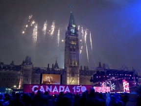 Fireworks explode behind the Peace Tower during a celebration on Parliament Hill on New Year's Eve, Saturday, Dec. 31, 2016 in Ottawa. Canada celebrates its 150th anniversary of Confederation in 2017.