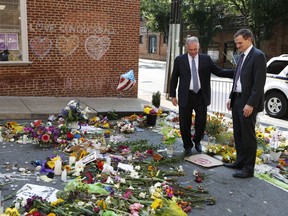 Sen. Tim Kaine, left, and Charlottesville Mayor Michael Signer visit a makeshift memorial Wednesday, Aug. 16, 2017, where Heather Heyer was killed when a car rammed into a crowd of people protesting a white nationalist rally.