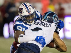 Alouettes' Jesse Joseph tackles Argonauts' Brandon Whitaker during first half Friday night at Molson Stadium.