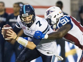 Alouettes' Jesse Joseph tackles Argonauts quarterback Jeff Mathews during first half action at Molson Stadium.