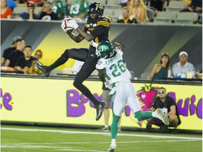 Hamilton Tiger Cats' Terrence Toliver (80) goes high to make a catch while being covered by Saskatchewan Roughriders defensive-back Tevaughn Campbell during game in 2016. The Alouettes acquired Campbell and draft picks on Monday in exchange for QB Vernon Adams Jr. and a draft pick.