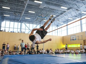 A Grade 11 student at Alexander von Humboldt school in Montreal performs a successful high jump during the school's Track & Field Day.