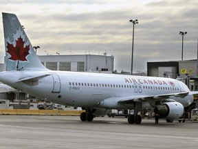 MONTREAL, QUE.: December 08, 2015 -- An Air Canada jet sits near a gate at Trudeau Airport in Montreal Tuesday December 08, 2015. (John Mahoney / MONTREAL GAZETTE)
John Mahoney, Montreal Gazette
