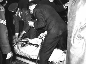 Pierre Laporte's body is taken from the trunk of 1968 Chevrolet on Oct. 18, 1970. (Montreal Star)