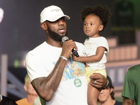 Cleveland Cavaliers' LeBron James speaks while holding his daughter, Zhuri, during the We Are Family Reunion at Cedar Point in Sandusky, Ohio, Tuesday, Aug. 15, 2017.